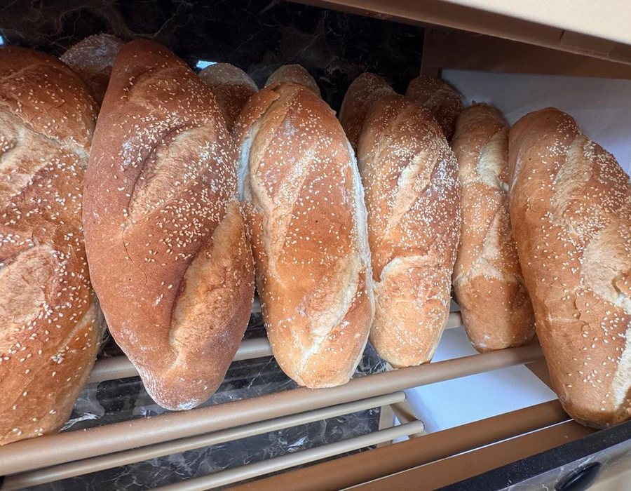 Oval sesame bread loaves baked fresh at Bakery Kissamos